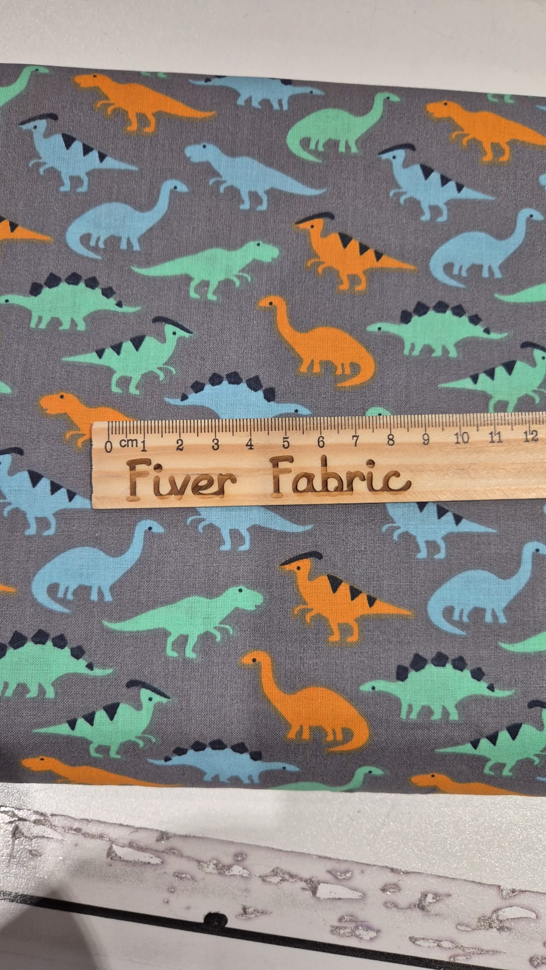 100% cotton dinosaurs on grey