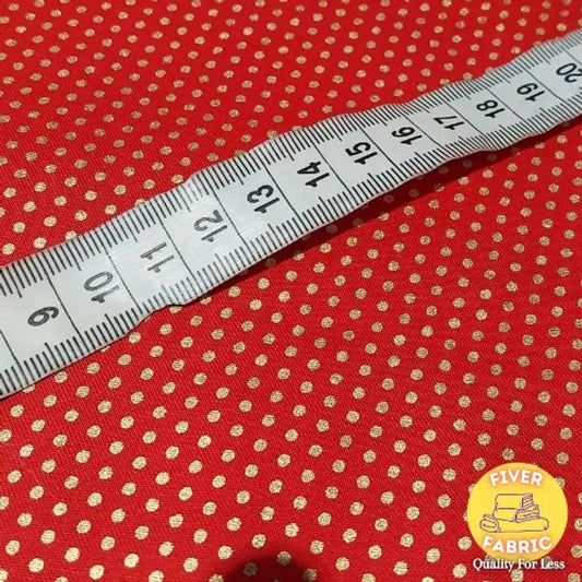 Gold spots on red cotton