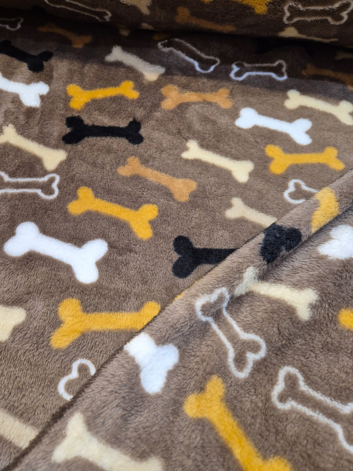 Multi colour Bones on brown cuddle fleece
